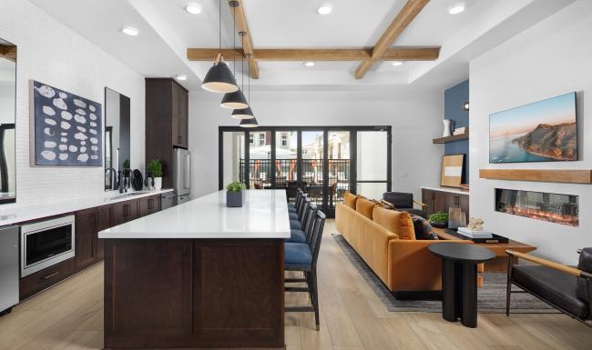 a large kitchen with a bar and couches