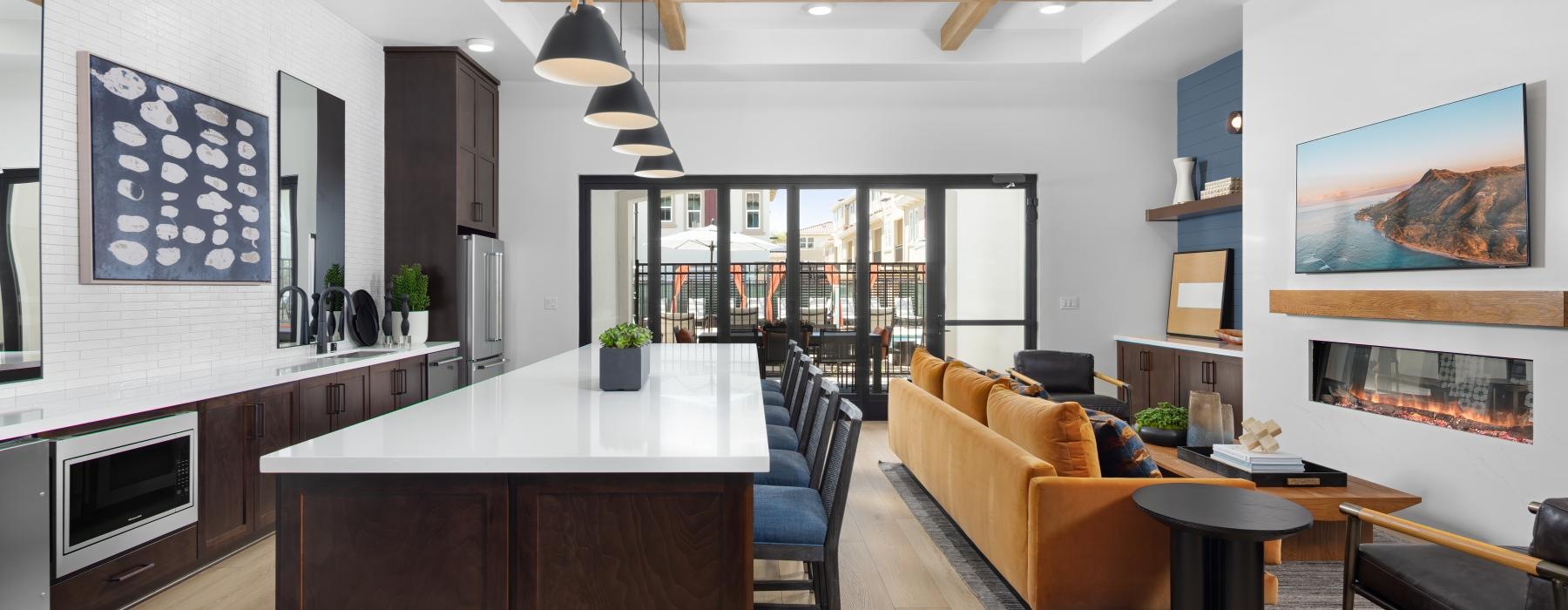 a large kitchen with a bar and couches