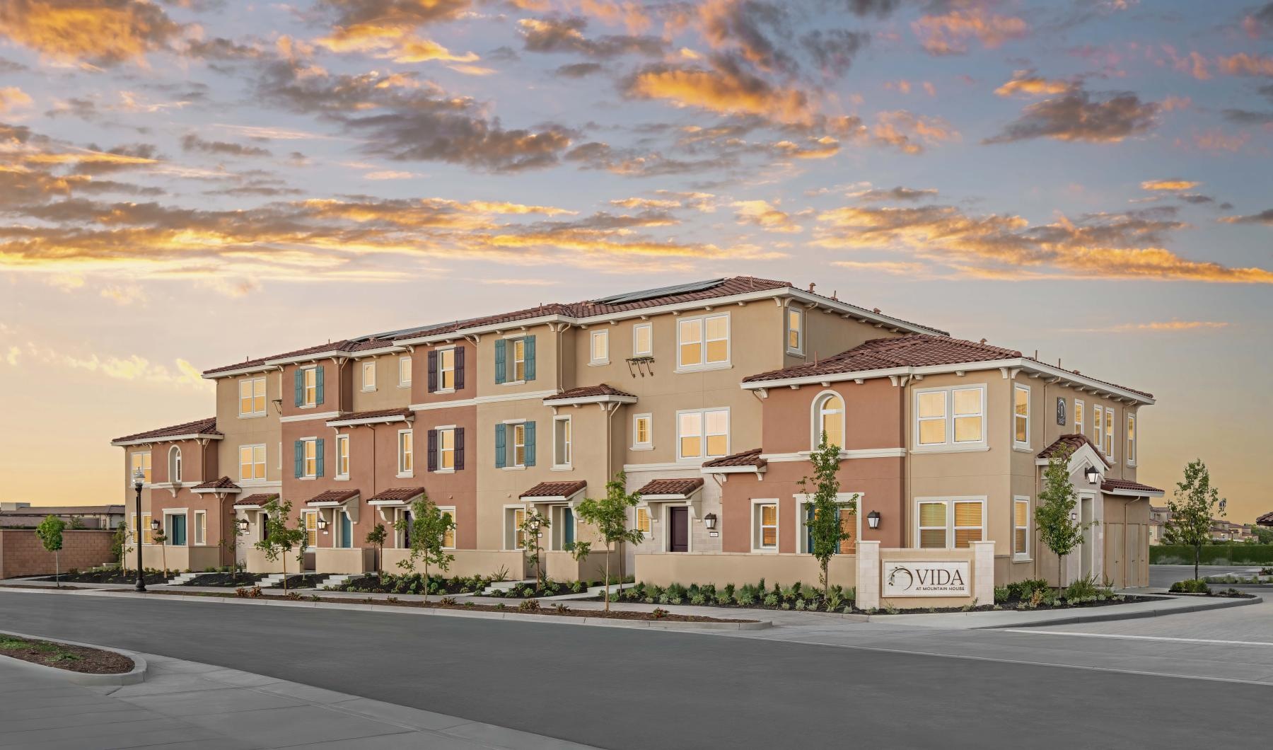 a building with a sunset in the background